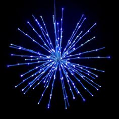 a large blue starburst is lit up in the dark