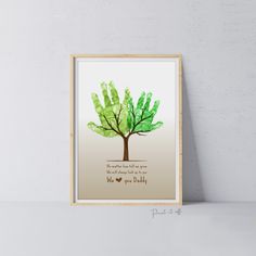 a green handprinted tree with the words, we love you daddy on it