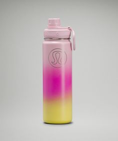 a pink and yellow water bottle sitting on top of a table