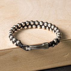 This bracelet features a tightly woven hand braided band with alternating genuine leather and .925 sterling silver handmade beads. The rich texture draws the eye, creating a unique, substantial, and intriguing braided leather bracelet that complements any outfit. Finished with a hook clasp that provides both - convenince and security. Perfect for the minimalist at heart, who likes just the right elevated touch. It can be worn as a stand-alone bracelet or stacked.SHOW YOUR FOREVER LOVE - A piece Modern Braided Jewelry For Everyday, Modern Adjustable Leather Bracelet With Sterling Silver Clasp, Adjustable Leather Jewelry With Sterling Silver Clasp, Adjustable Braided Sterling Silver Bracelet, Modern Silver Leather Bracelet With Sterling Clasp, Adjustable Modern Braided Bracelets, Adjustable Silver Leather Bracelet With Sterling Silver Clasp, Handmade Silver Leather Bracelets, Handmade Leather Silver Bracelets