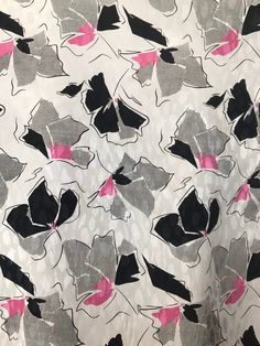 a white and black floral print with pink accents