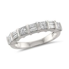 a white gold ring with princess cut diamonds on the sides and baguetts in the middle