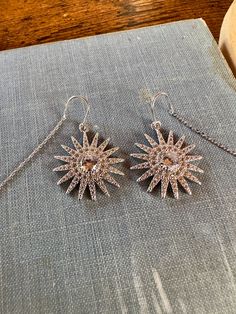 This listing is for one pair of cubic zirconia starburst drop earrings. They hang from stainless steel threaders. The long chain easily threads through the earlobe, and then the hook hangs within the piercing to create a graceful and elegant look. Because of the u-hook that hangs within the ear, these earrings can comfortably be worn without fear of them falling out all day long. Sparkling Silver Starburst Jewelry, Dazzling Silver Starburst Jewelry, Starburst Cubic Zirconia Jewelry Gift, Silver Crystal Earrings With Cubic Zirconia, Silver Crystal Earrings With Cubic Zirconia Ear Wire, Silver Cubic Zirconia Crystal Earrings With Ear Wire, Autumn Earrings, Dangle Earrings Silver, Le Crochet