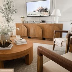 a living room filled with furniture and a flat screen tv mounted to the side of a wall