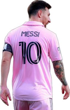 a man with tattoos on his arm wearing a pink soccer jersey