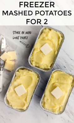 three tins filled with mashed potatoes on top of a white counter next to butter