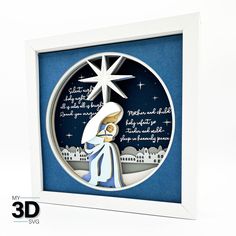 a paper cut nativity scene with the birth of jesus in blue and white frame