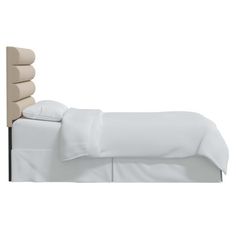 a bed with white sheets and pillows on it