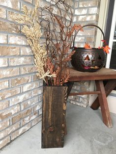 a potted plant sitting on top of a wooden table next to a brick wall