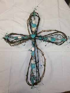 a cross made out of branches and beads