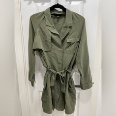 Army Green Trench Jacket/Dress. Unworn Without Tags. Spring Utility Workwear Dress, Spring Utility Dress For Workwear, Long Sleeve Khaki Utility Jacket For Spring, Khaki Long Sleeve Utility Jacket For Spring, Casual Spring Utility Jacket With Belt, Casual Belted Utility Jacket For Spring, Belted Long Sleeve Utility Jacket, Belted Utility Jacket, Casual Long Sleeve Outerwear With Tie Waist