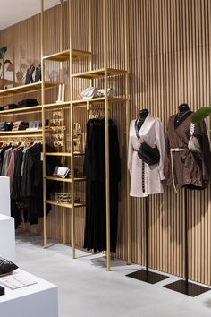 a clothing store with wooden shelves and clothes on display