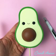 an avocado shaped lollipop on a stick