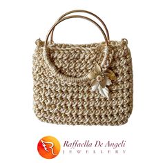 Handmade crochet bag with ivory-coloured cord yarn and gold-coloured lurex with round handles in gold-plated brass, golden aluminum chain shoulder strap and decorations in the shape of ivory and gold-coloured flowers and leaves and Swarovski crystal set with glass beads at the center of the flower. Made in Turin, Italy. Luxury White Crochet Bag, Luxury Beige Crochet Bag With Handles, Elegant Beige Straw Bag With Gold-tone Hardware, Elegant Crochet Bag With Gold-tone Hardware, Elegant Gold Straw Bag With Gold-tone Hardware, Luxury Gold Straw Bag, Elegant Crochet Bag With Detachable Handle In Natural Color, Elegant Natural Crochet Bag With Detachable Handle, Gold Rectangular Crochet Bag With Braided Handles