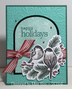 a handmade christmas card with two birds on the tree branch and merry holidays sentiment