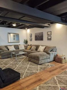 a living room with couches, chairs and rugs on the floor in it