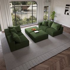 a living room filled with green couches and a coffee table in front of a large window