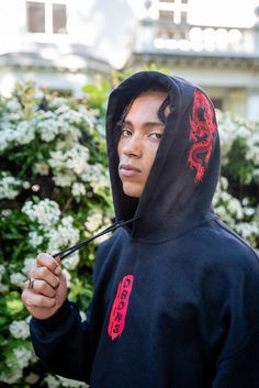 a young man with dreadlocks standing in front of trees Embroidered Sweatshirt For Streetwear In Winter, Embroidered Sweatshirt For Winter Streetwear, Techwear Hoodie With Double-lined Hood And Crew Neck, Embroidered Red Hoodie For Streetwear, Red Embroidered Hoodie For Streetwear, Urban Hooded Sweatshirt With Embroidered Logo, Streetwear Hoodie With Embroidered Logo, Black Embroidered Hooded Hoodie, Hoodie Sweatshirt With Embroidered Logo For Streetwear