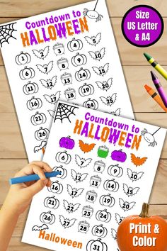 a hand holding a marker next to a printable halloween activity sheet with pumpkins and bats