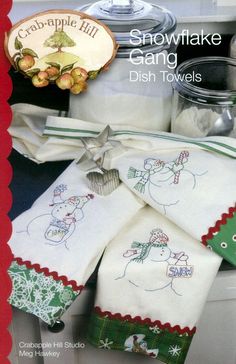 the snowflake gang dish towels are on display in front of other kitchen items