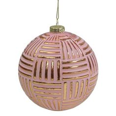 a pink and gold ornament hanging from a string