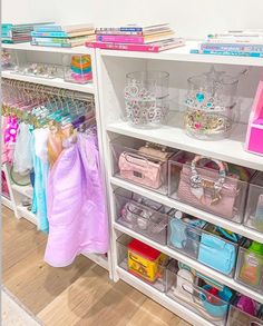 an organized closet with clear bins and plastic baskets on the bottom shelf for storage