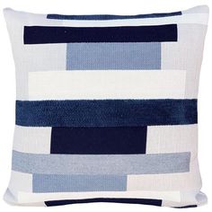 a blue and white pillow on a white background