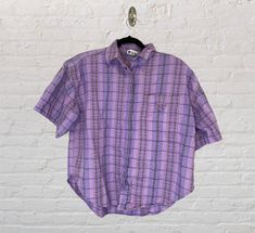 "Vintage 80s or 90s purple plaid oversized short sleeve shirt. Buttons down and buttons are hidden. Has a large pocket on the front right side. Has shoulder pads which can always be removed for a more modern look. Well made shirt. Brand: Khazana Size: Medium (oversized fit) Material: 100% cotton Made in India Measurements (taken flat): Length: 23\" Chest: 22\" Sleeves: 8.5\"" Oversized Short Sleeve Shirt, Purple Dress Shirt, Purple Plaid, Purple Shorts, Purple Shirt, Black Midi Skirt, Plaid Tops, Purple Fashion, Look Plus