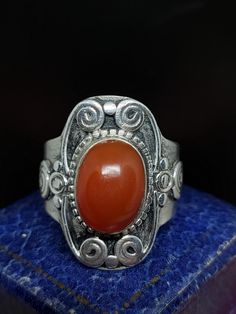 This stunning ring dates from the early to mid 20th century featuring a large natural cabochon carnelian Gemstone set in sterling silver saddle style ring traditional in Tibet. The ring is unmarked and tested  UK size - U US size - 10 Message me any questions  ITEM - S1866 Vintage Gemstone Cabochons For Anniversary, Vintage Round Gemstone Cabochons, Vintage Oval Moonstone Ring Hallmarked, Classic Carnelian Jewelry Hallmarked, Vintage Carnelian Engraved Jewelry, Antique Oval Cabochon Moonstone Ring, Antique Moonstone Oval Cabochon Ring, Antique Moonstone Ring, Oval Cabochon, Vintage Carnelian Hallmarked Ring