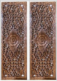 two wooden doors with intricate carvings on the front and back panels, one showing an image of