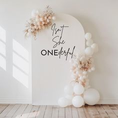 an arch with balloons and confetti hanging from it that says get set, see onedery