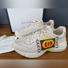 Gucci Men's Apollo Size Gucci 9+ (Us 10) Insole Length: Approximately 28 Cm New In Box, Guaranteed Authentic Made In Italy 100% Authentic White Rubber Sole Gucci Name In Shoe, Stars On Sole With Gucci Name Logo Gucci Printed Feature In Yellow And Green And Red On Side Of Shoe Lace-Up Closure Low Heel: 1.6" Height Designer Beige Leather Sneakers, Gucci Low-top Cream Sneakers, Gucci Leather Sneakers With Logo, Gucci Cream Low-top Sneakers, Beige Leather Sneakers With Logo, Beige Round Toe Sneakers With Logo, Gucci Casual Cream Sneakers, Casual Gucci Cream Sneakers, Casual Cream Gucci Sneakers