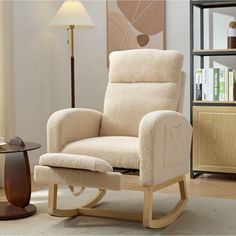 a living room with a rocking chair and table