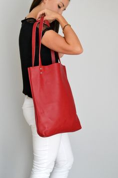 "SIMPLE LEATHER TOTE BAG Please click + More at the end of the description to see more details. Dimensions: Height: 15.5'' 39 cm Width: 12.2'' 31 cm Handles: 23.6'' 60 cm Handle drop: 10.2\" 26 cm Casual and simple tote bag made from high quality pebbled leather. It is slim, lightweight, strong and fits comfortably over the shoulder. * Highest quality Italian leather * Includes interior zipped pocket and key chain * Zipper & Hardware (Luxury gold or silver) * Fits a laptop (up to 13 inch) * Modern Red Satchel Tote, Modern Red Tote Satchel, Red Bags With Large Capacity For Everyday Use, Everyday Red Satchel With Double Handle, Everyday Red Double Handle Satchel, Red Everyday Bag With Top Carry Handle, Red Tote Bag With Leather Handles, Red Top Handle Shoulder Bag For Everyday, Everyday Red Top Handle Shoulder Bag