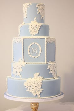 a three tiered blue and white wedding cake