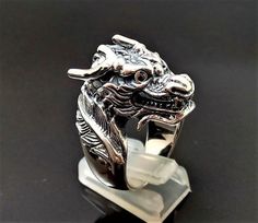 Chinese Dragon RingPure 925 Sterling Silver Unisex Ring with Black Onyx EyesThis beautiful Exclusive Design Dragon Ring has been Fabulously casted with .925 Sterling SilverThe weight of the Ring is 27-28 grams*please inquire if you don't see your size listed*Please allow 2-3 weeks shipping as we are in Bangkok Thailand at this timeWe are a Los Angeles based company operating out of Thailand so that we may bring you the highest quality items at the most competitive prices. Just search and compare Traditional Dragon Design Collectible Jewelry, Black Spiritual Jewelry With Dragon Design, Spiritual Black Jewelry With Dragon Design, Traditional Black Hallmarked Jewelry, Black Jewelry With Dragon Design Collectible, Black Symbolic Sterling Silver Jewelry, Black Sterling Silver Symbolic Jewelry, Black Carved Ring Jewelry, Black Dragon Design Jewelry Gift