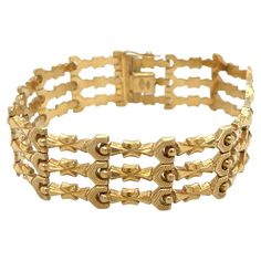 A stunning exemplar of mid-20th century jewelry artistry, this vintage bracelet from the 1940s-1950s era exudes timeless elegance and sophistication. Masterfully crafted in rich 18k yellow gold, verified by the 750 stamp, the design features a bold three-row link pattern with an Art Deco-inspired aesthetic. Measuring a rare 8 inches in length and 18.4mm in width, the bracelet commands attention with its substantial and striking presence on the wrist. The links are meticulously crafted, showcasing the intricate details and geometric motifs emblematic of the Art Deco style. The plunger clasp is secured with a folder safety catch, ensuring a secure and comfortable fit. Despite its age, the bracelet remains in very good condition, a testament to its exceptional quality and care. Weighing an el Prada Bracelet, Vintage Prada, Inspired Aesthetic, Art Deco Stil, Estilo Art Deco, Vintage Bracelet, Fine Jewelry Collection, Art Deco Inspired, Vintage Bracelets