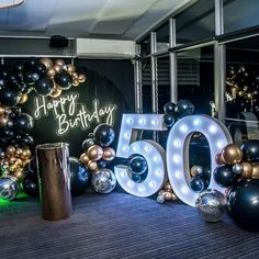 a 50th birthday party with balloons and lights