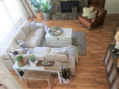 an overhead view of a living room with couches, coffee table and other furniture