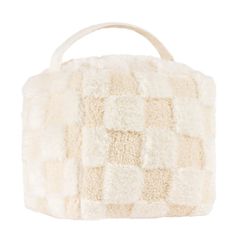 a white handbag that is made out of sheepskin and has a wooden handle