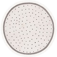 a white rug with black dots on the top and bottom, in a circle shape