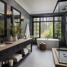 a bathroom with a tub, sink and large windows