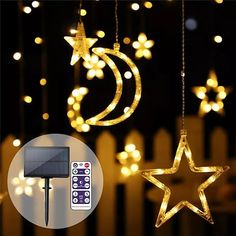 some lights that are hanging in the air with stars and a remote control next to them