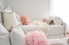 a white couch with pillows and blankets on it