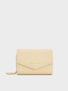 A practical accessory with an ultra-stylish minimalist look, this envelope wallet can hold everything from your credit cards to loose change. Finished in a sleek and versatile beige shade with subtle stitch-trimming, this piece is fitted with a magnetic closure at the front that opens up to reveal an inner compartment that will keep you organised all day long, plus a zip compartment at the back for added storage. Slip it into your daily bag or jeans pocket for convenient use. Small Wallets For Women, Belted Blazer Dress, Stocking Suffers, Jeans Pocket, Kitty Accessories, Hello Kitty Accessories, Womens Wallet, Cute Wallets, Loose Change