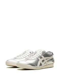 "Find ONITSUKA TIGER Mexico 66™ Sd \"\"pure Cream\"\" Sneakers on Editorialist. silver-tone off-white calf leather metallic effect signature Tiger stripes round toe front lace-up fastening logo patch at the tongue branded insole branded heel counter flat rubber sole These styles are supplied by a premium and authenticated sneaker marketplace. Stocking only the most sought-after footwear, they source and curate some of the most hard to find sneakers from around the world." Silver Sneakers With Metallic Logo For Streetwear, Sporty Metallic Silver Leather Sneakers, Silver Sneakers With Rubber Sole For Streetwear, Metallic Leather Sneakers For Streetwear, Metallic Sneakers With Rubber Sole For Streetwear, Modern Silver Sneakers With Rubber Sole, Silver Leather Sneakers With Contrast Sole, Sporty Silver Sneakers With Contrast Sole, Silver Casual Sneakers With Metallic Logo