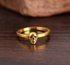 Tiny skull ring, gold skull, modern skull ring, eternity band, minimal skull,  Hand-Made jewelry, Halloween  Material:- Brass Size:- Any The ring can be customized on request and the gemstone can be made to any gemstone you want. Same Design Ring Are Upload With Any Gemstone. Please Visit Our Shop to View Complete Collection. If You Need Faster Shipping, Please Contact us ♥Please Make Sure to Include The Correct Address During Before Ordering. You Can return the Item within 30 Days After Successful Delivery. We offer a 100% Money Back Guarantee If You are Not Satisfied With Your Purchase. Return Charge Will Be Paid By Buyer Only. Thank you for visiting my shop! jaipurjewelryIn Skull Ring Gold, Minimal Skull, Jewelry Halloween, Gold Skull, Skull Hand, Skull Ring, Hand Made Jewelry, Eternity Band, Ring Gold