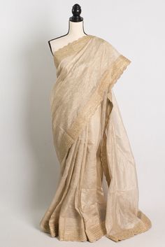 Elevate your ethnic wardrobe with this stunning Semi Tissue Designer Partywear Saree in Light Brown. The saree is beautifully crafted with intricate golden stitched border, adding a touch of elegance to the overall look. The light brown color exudes a modern yet traditional vibe, making it perfect for any festive occasion or party. Pair it with statement jewelry and a stylish blouse to make a head-turning entrance at any event. Color : Brown and Gold.    Blouse Piece : Yes ( cut and separated from the saree ). Fall Pico : Yes.  Care: Dry-Clean Only. Golden Tissue Saree, Light Golden Brown, Tissue Saree, Stylish Blouse, Wear Saree, Party Wear Sarees, Bollywood Saree, Indian Sarees, Golden Brown