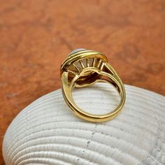 New, but old pieces, never worn, recently acquired from a premiere jeweler located in Minneapolis, MN for many years- a rare opportunity. 18KT yellow gold genuine, double bezel, round, mabe pearl ring Size 6.50 Sizable by us for a fee or your local jeweler Weight: 12.2 grams Band width: 3mm in back 11.50~12mm round mabe pearl Stamped 18k Mabe Pearl, Pearl Ring, Minneapolis, Ring Size, Yellow Gold, Size 6, Band, Ring, Yellow