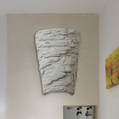 there is a white sculpture hanging on the wall